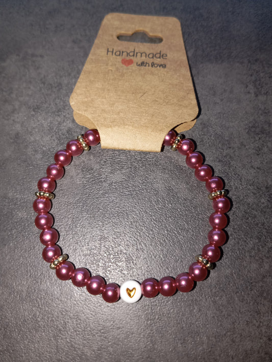 Armband dunkelpink mit goldenen Herz